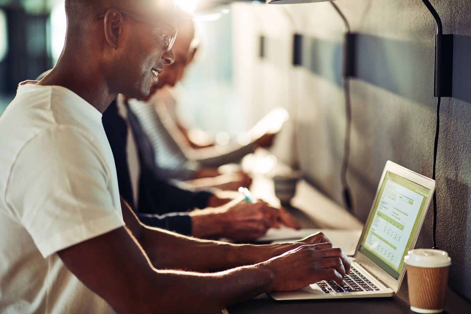 A person is working on a laptop in a dimly-lit environment, focused on email marketing for the casino and gambling industry.